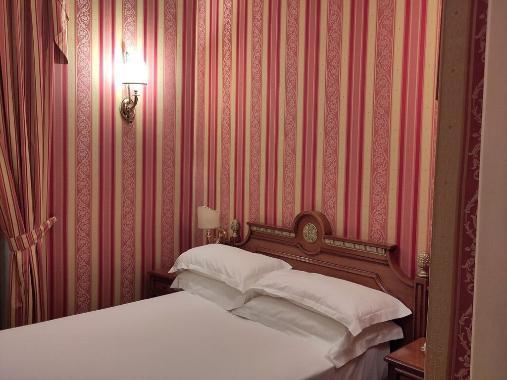 Illustratieve demofoto: Hotel room in Rome with red and yellow tapestry